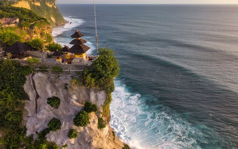Uluwatu Temple shrines on a clifftop above the Indian Ocean surf