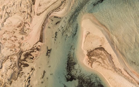 Aerial view of the pale sand bars and turquoise shallows of Elafonisi beach