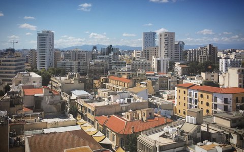 Rooftops of central Nicosia with old and modern buildings under a clear blue sky
