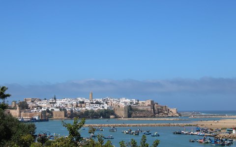 The old walled quarter and white houses of Rabat above the river mouth and blue sea