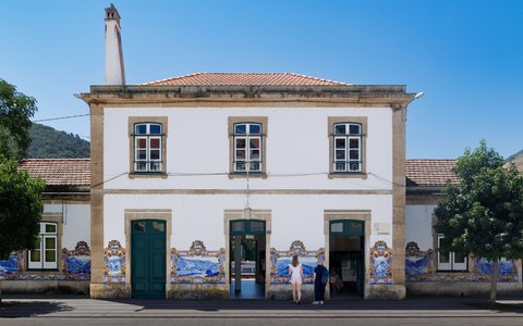 The tiled front of Pinhao's historic railway station under a blue sky