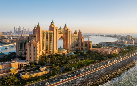 Aerial view of the Atlantis The Palm hotel at sunset, with the Palm Jumeirah road and the sea